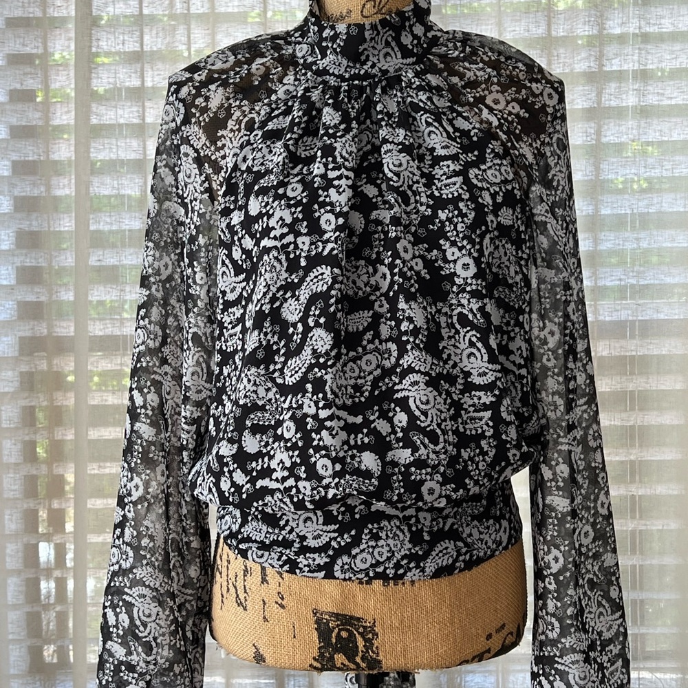 Beautiful top with sheer back, lined front, covered buttons, button down back.